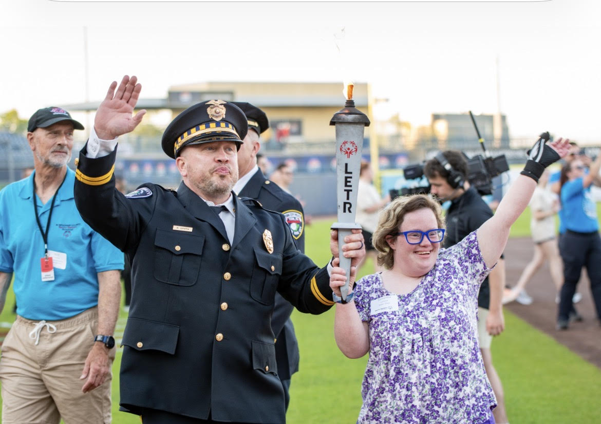 Image: A photo of Samantha Lurwick holding the Special Olympic Torch 